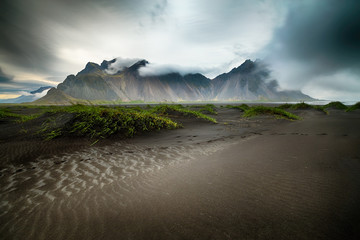 Scenic view of Rippled beach black sand. Popular tourist attraction. Location famous place Stokksnes cape, Vestrahorn (Batman Mountain), Iceland, Travel Destinations Concept	
