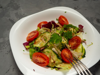 Fresh vegetable salad dressed with olive oil and balsamic vinegar