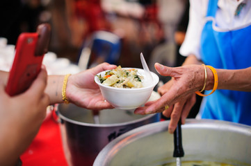 feeding to hand the poor helping  beggar in social. poverty concept