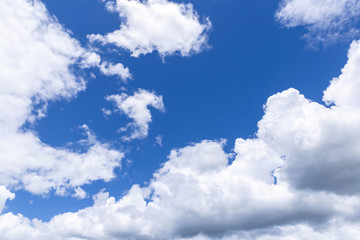 Blue sky background with white clouds, rain clouds on sunny summer or spring day.