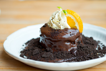Chocolate fondant and orange slice with whip cream