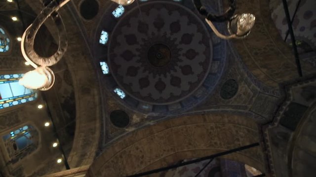 Inside shooting of the Islamic mosque dome. Picturesque designed fescues, art, traditional architecture. Temple, religion, faith. Exploring the culture, world travel