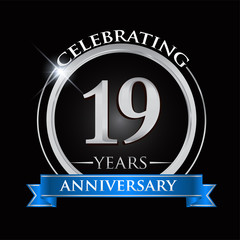 Celebrating 19 years anniversary logo. with silver ring and blue ribbon.