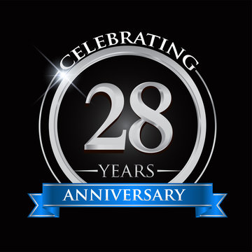Celebrating 28 years anniversary logo. with silver ring and blue ribbon.