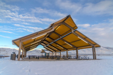 Fototapeta na wymiar Pavilion against snowy mountain and cloudy sky