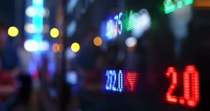 Stock market display screen in city at night