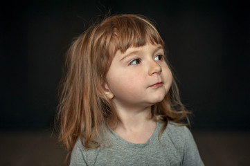 little girl portrait, small girl with long hair on black background close up, - 257802335