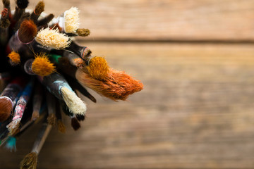 bundle of artist paintbrush at tin can, rusty wooden