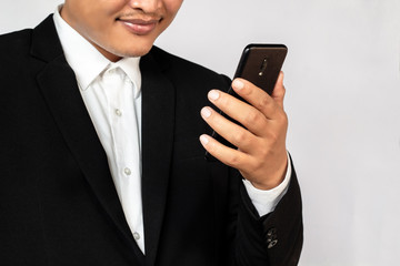 Male hand holding a  smartphone on white background, business concept.