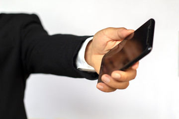 Male hand holding a smartphone on white background, business concept.