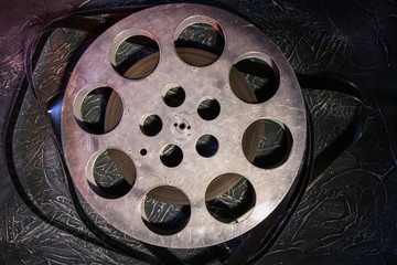 35 mm film reel with dramatic lighting on a dark background
