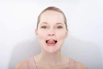 facial gymnastics. the girl does massage and rejuvenating exercises for the face