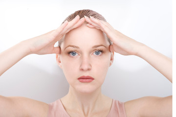 Naklejka premium facial gymnastics. the girl does massage and rejuvenating exercises for the face