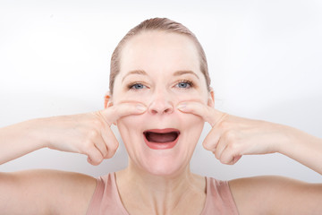 facial gymnastics. the girl does massage and rejuvenating exercises for the face