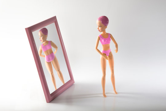 doll with food addiction trying to induce vomiting. Signs, consequences, symptoms and treatment of anorexia. the girl sick Problems with weight, food addiction in women, bulimia and anorexia