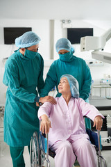 Surgeons preparing patient to operation