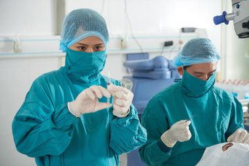 Surgeons making operation on eyes