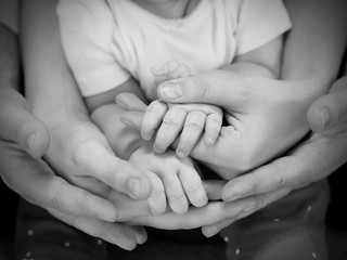 hands of complete family: father, mother and child. Relationship