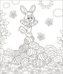 Little Easter Bunny on a pile of colorfully decorated eggs on grass on a sunny spring day, black and white vector illustration in a cartoon style for a coloring book