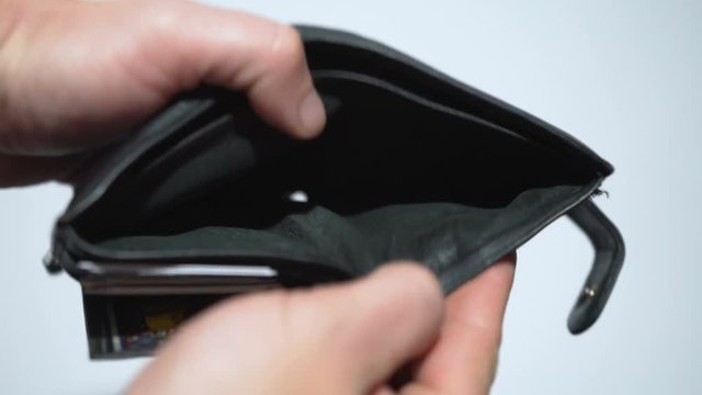 Man bankrupt arrears shows empty wallet with no money on white background