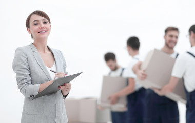 Woman manager holding clipboard on blurred background with mover