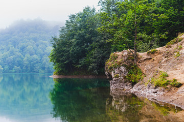 mountain lake in the misty morning