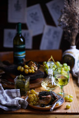 quail in grape leaves with grapes.style vintage