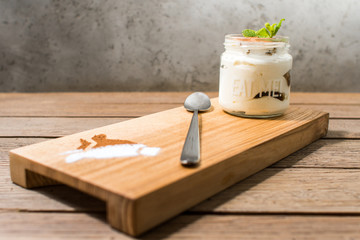 Fototapeta na wymiar panakota in a jar on a kitchen board with a spoon