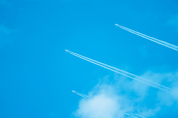 blue sky with airplane and trail