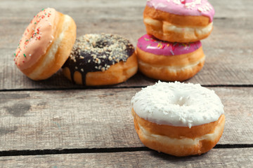 Obraz na płótnie Canvas Glazed donuts on wooden background