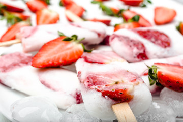 Natural juicy strawberry popsicles with yogurt or ice cream with berries.