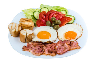 breakfast fried egg fresh vegetables fried bacon and olives on a white plate isolated