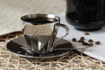 close up coffee cup and grains on wooden table