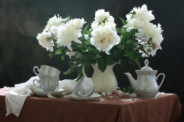 Bouquet of peonies in a white vase