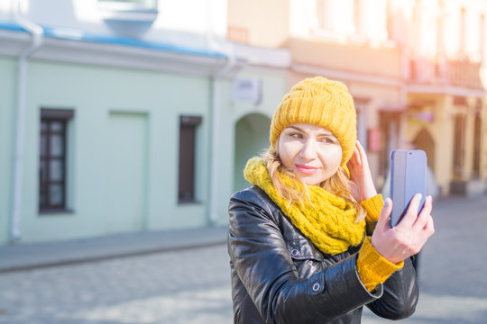young stylish smiling pretty woman taking pictures selfie her phone front city street