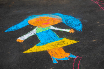 Outdoor kids graffiti on the floor with chalk