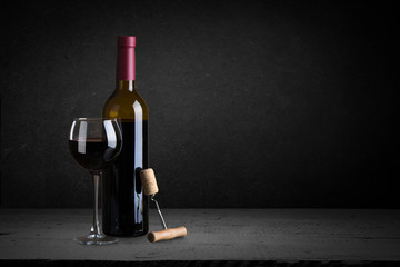 Expensive wine bottles collection and wooden barrel in the cellar, wine tasting and production...