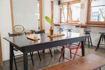 Interior of wooden table and chairs with foliage decoration