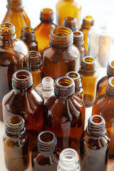 Group of various medical vials background. Many small brown bottles without labels