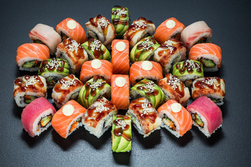 Japanese cuisine. Sushi set on dark background