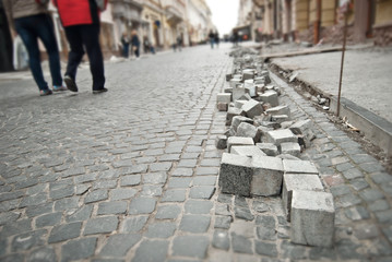 Paving the street in the city. Replacement of old paving tiles. Repairs. Chernivtsi, Ukraine, Europe, March 2019.