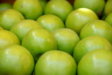 Heap of green ripe apples close up
