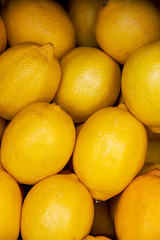 Heap of yellow ripe lemons close-up top view