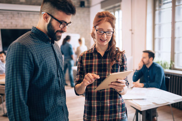 Portrait of young architects discussing in office