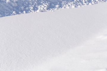 Fototapeta na wymiar Winter, the surface of fresh fluffy snow, close-up, snowdrift, bumps on the top of the frame