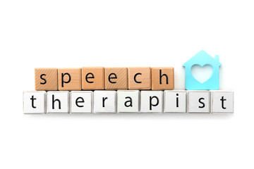 Cubes with text SPEECH THERAPIST on white background