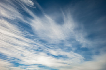 Blue sky background with tiny stratus cirrus striped clouds. Clearing day and Good windy weather
