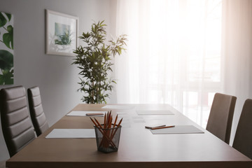 Table with stationery prepared for business meeting in conference hall