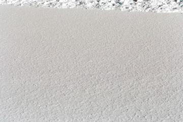 Winter, the surface of fresh fluffy snow, glare, snowflakes