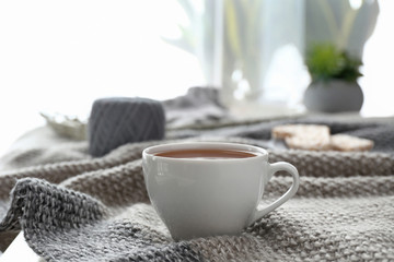 Obraz na płótnie Canvas Cup of hot tea on plaid